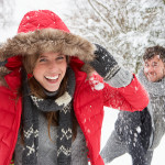 Young couple having snowball fight