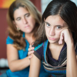 Teenager problems - Mother comforts her troubled teenage daughte