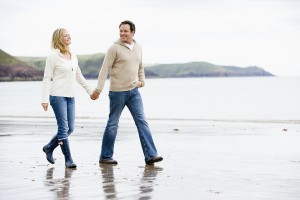 Couples Walking On Beach Holding Hands Smiling