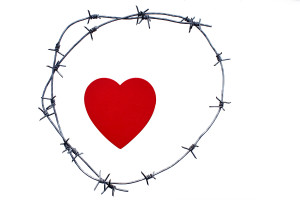 heart is surrounded by a barbed wire