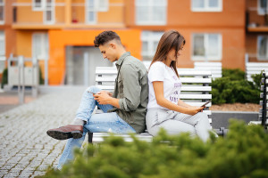 Mobile Phone Addiction Concept - Couple Looking At Their Mobile